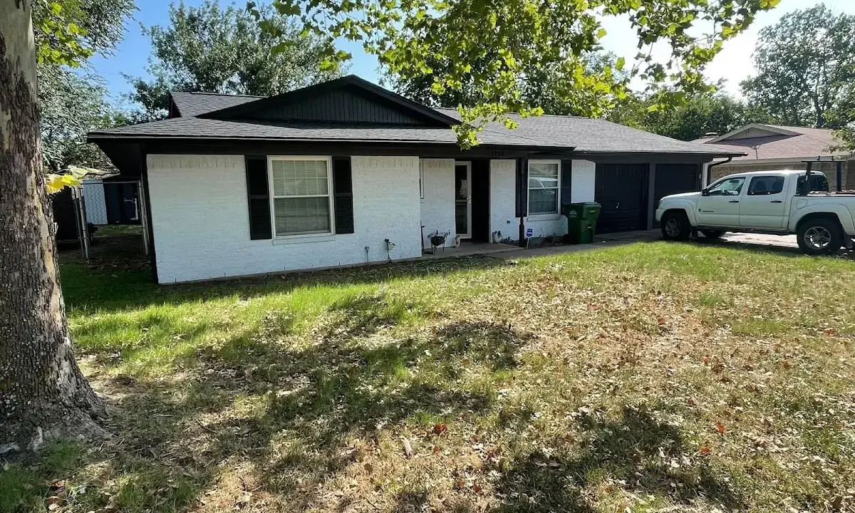 Professional roofing crew working on a residential roof in Englewood
